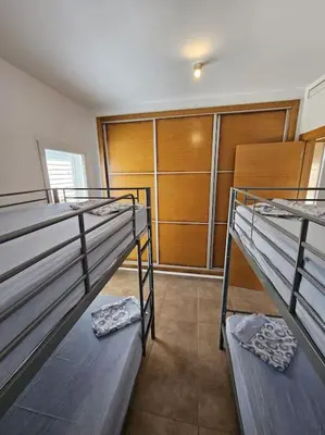 two bunk beds in a room with a closet at Chalet frente al Mar in Cullera
