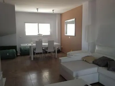 a living room with a couch and a table at Chalet frente al Mar in Cullera