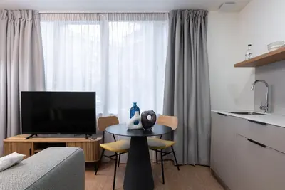 a living room with a table in front of a window at Smartr Valencia Turia in Valencia