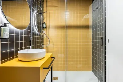 a bathroom with a sink and a shower at Smartr Valencia Turia in Valencia