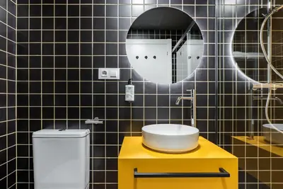 a bathroom with a sink and a mirror and a toilet at Smartr Valencia Turia in Valencia