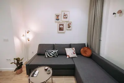 a living room with a couch and a table at Nuevo y moderno loft en amistat in Valencia