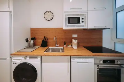 a kitchen with a sink and a microwave at Nuevo y moderno loft en amistat in Valencia