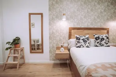a bedroom with a bed and a mirror at Nuevo y moderno loft en amistat in Valencia
