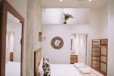 a bedroom with two beds and a mirror at Nuevo y moderno loft en amistat in Valencia
