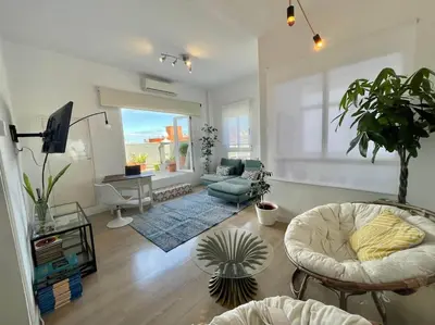 a living room with a couch and a table at Valencia Sky Haven in Valencia