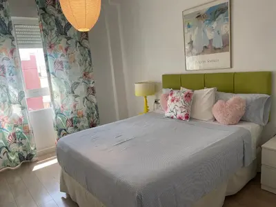 a bedroom with a bed with two pillows on it at Valencia Sky Haven in Valencia