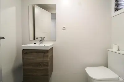 a bathroom with a toilet and a sink and a mirror at Big Flat Ruzafa in Valencia