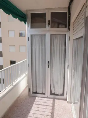 a pair of doors on the balcony of a house at Malvarrosa, 8-54 in Cullera