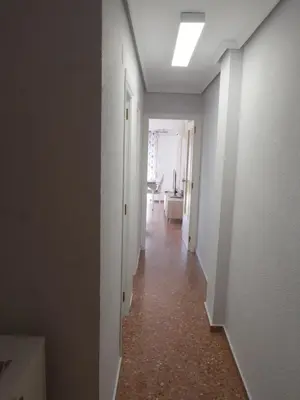a hallway with white walls and a room with a hallway at Malvarrosa, 8-54 in Cullera