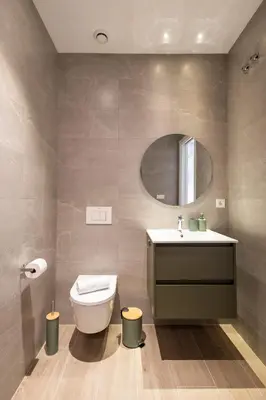 a bathroom with a toilet and a sink and a mirror at Yard Patraix by Concept Flats in Valencia