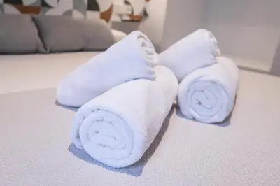two towels sitting on top of a bed at Yard Patraix by Concept Flats in Valencia
