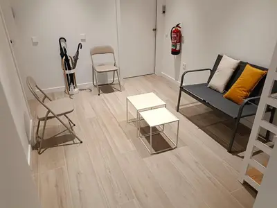 a living room with chairs and a couch and a table at Yard Patraix by Concept Flats in Valencia
