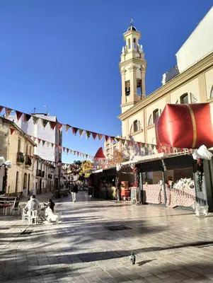 a city street with a clock tower in the background at Yard Patraix by Concept Flats in Valencia