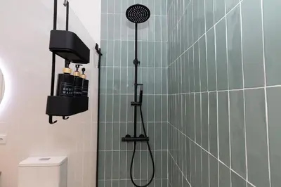 a bathroom with a shower with a shower head at Apartment Casa Novi - Close to Beach, City Center & Metro in Valencia