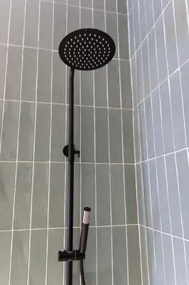 a black stool in front of a white tiled wall at Apartment Casa Novi - Close to Beach, City Center & Metro in Valencia