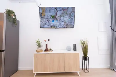 a cabinet in a kitchen with a painting on the wall at Apartment Casa Novi - Close to Beach, City Center & Metro in Valencia