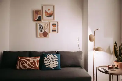 a couch in a living room with pictures on the wall at Nuevo y acogedor loft en Amistat in Valencia