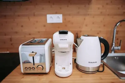 two coffeemakers and a coffee maker on a counter at Nuevo y acogedor loft en Amistat in Valencia