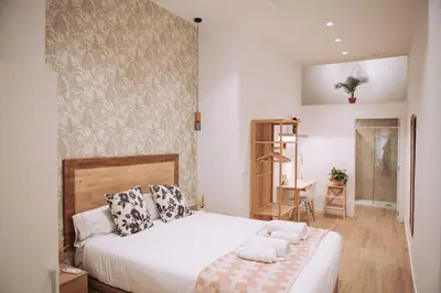 a bedroom with a large white bed with pillows at Nuevo y acogedor loft en Amistat in Valencia