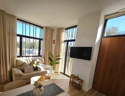 a living room with a couch and a tv at HOB Las Ciencias I in Valencia