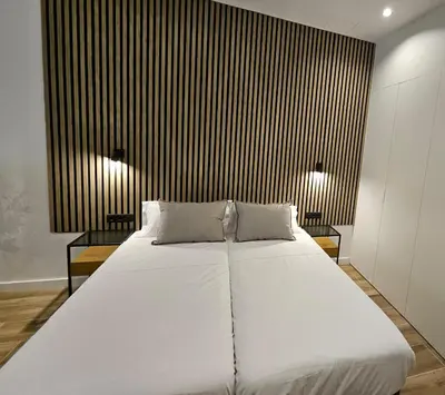 a bedroom with a large white bed with two side tables at HOB Las Ciencias I in Valencia