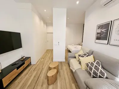 a living room with a couch and a flat screen tv at HOB Las Ciencias Terrace III in Valencia