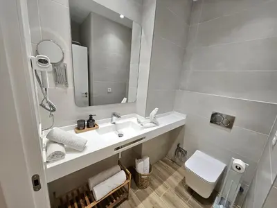 a bathroom with a sink and a toilet and a mirror at HOB Las Ciencias Terrace III in Valencia