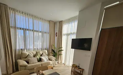 a living room with a couch and a large window at HOB Las Ciencias Terrace III in Valencia