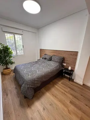 a bedroom with a bed and a potted plant at Arena apartment in Faro de Cullera