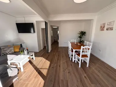 a living room with a couch and a table at Arena apartment in Faro de Cullera