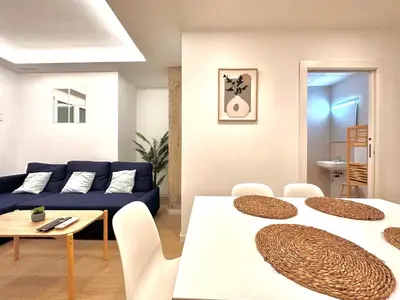 a living room with two tables and a blue couch at Apartamento Hierros VLC in Valencia