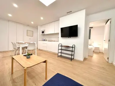 a living room with a table and a dining room at Apartamento Hierros VLC in Valencia