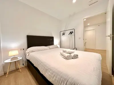a bedroom with a large bed with towels on it at Apartamento Hierros VLC in Valencia