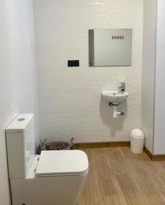 a bathroom with a white toilet and a sink at Blue House Valencia in Valencia