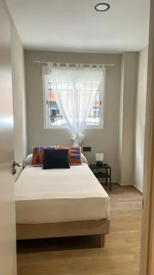a bedroom with a large bed with a window at Blue House Valencia in Valencia
