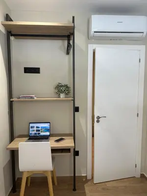 a laptop computer sitting on a desk next to a door at Blue House Valencia in Valencia
