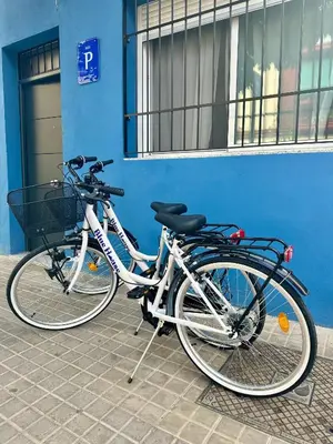 two bikes parked in front of a blue building at Blue House Valencia in Valencia