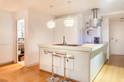 a kitchen with a white island with a sink at Loft Valencia centro - Vive el corazón de la ciudad in Valencia