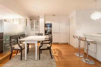 a dining room with a white table and chairs at Loft Valencia centro - Vive el corazón de la ciudad in Valencia