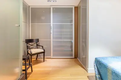a bedroom with a bed and a chair and a closet at Loft Valencia centro - Vive el corazón de la ciudad in Valencia