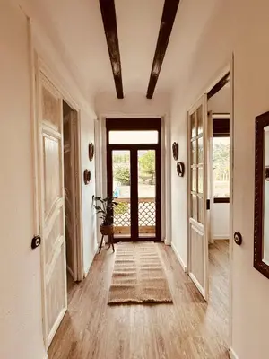 a hallway with a door leading to a patio at La Teja in Losa del Obispo