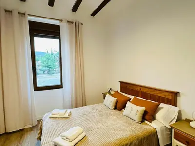 a bedroom with a bed with two towels on it at La Teja in Losa del Obispo
