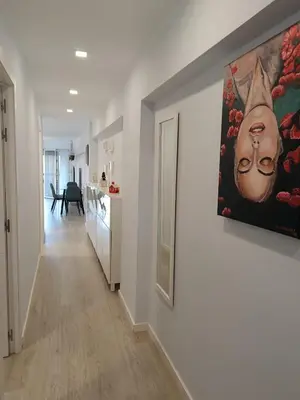 a hallway of a home with a painting on the wall at Alice Home in Puebla de Farnals