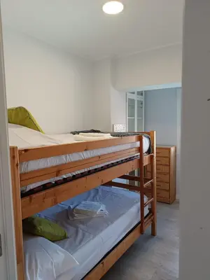 two bunk beds in a room with a mirror at Alice Home in Puebla de Farnals