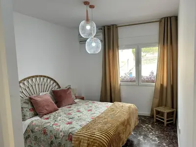 a bedroom with a bed and a window at La Roca in Losa del Obispo