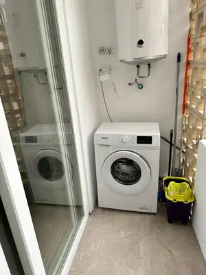 a laundry room with a washing machine and a washer at La Roca in Losa del Obispo