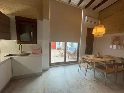 a kitchen with a table and a dining room at Dream Big with jacuzzi and terrace in Ruzafa in Valencia