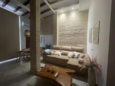 a living room with a couch and a table at Dream Big with jacuzzi and terrace in Ruzafa in Valencia