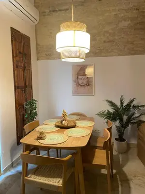 a dining room table with chairs and a chandelier at Dream Big with jacuzzi and terrace in Ruzafa in Valencia
